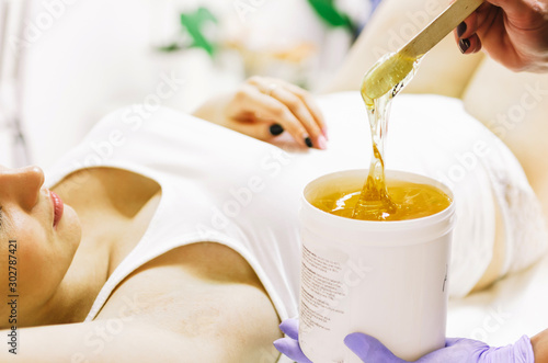 woman doing hot sugar wax hair removal