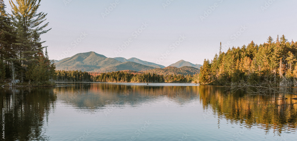 Ταπετσαρία Kayaking in Boreas Ponds in the Adirondacks on a glassy lake with Mount Marcy and the high peaks in the background as the sun is setting