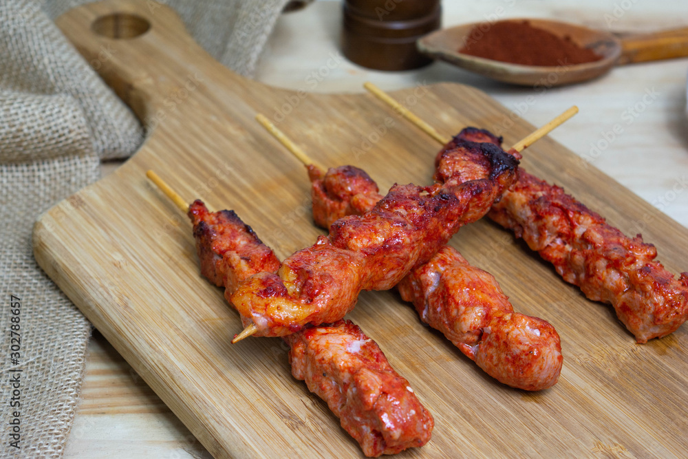 Pinchos morunos or meat skewer. Typical Spanish cuisine dish made with pork or chicken carn marinated with garlic and paprika Pinchos morunos or meat skewer. Typical Spanish cuisine dish made with pork or chicken carn marinated with garlic and paprika