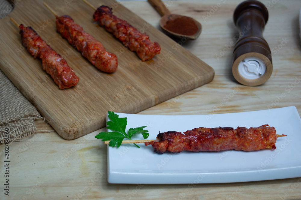 Pinchos morunos  or meat skewer. Typical Spanish cuisine dish made with pork or chicken carn marinated with garlic and paprika