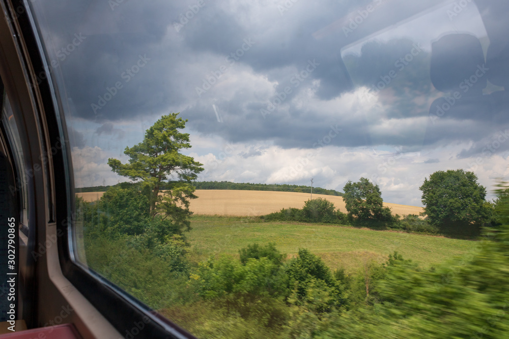 Fototapeta premium View from train window overlooking countryside in motion.