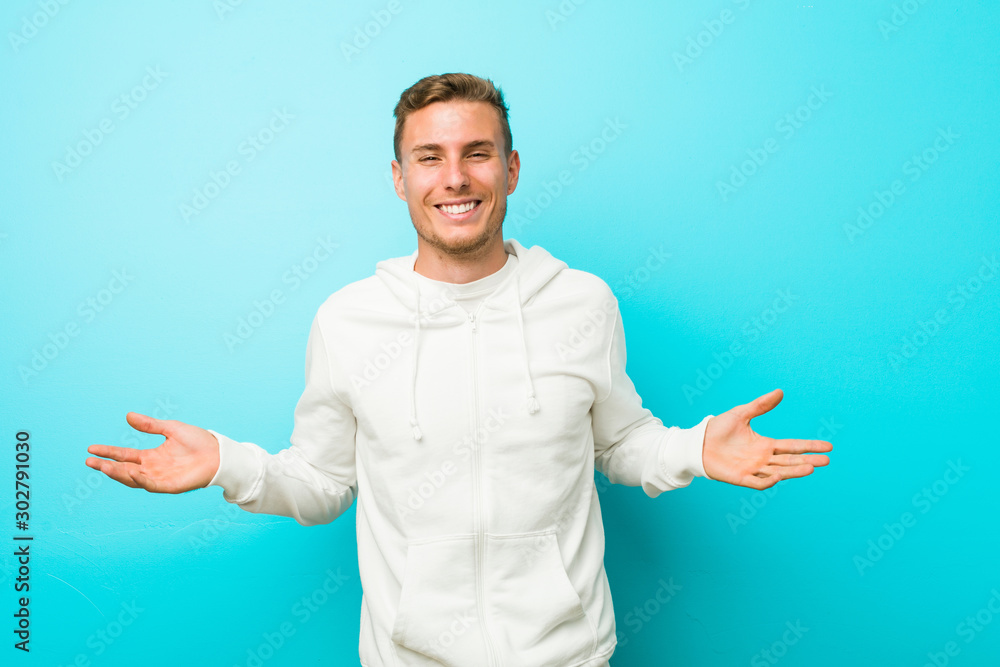 Young caucasian sport man showing a welcome expression. Young caucasian sport man showing a welcome expression.