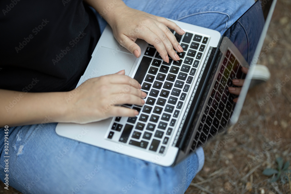 Fototapeta premium a woman working with laptop