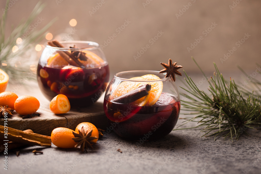  Christmas mulled wine delicious holiday like parties with orange cinnamon star anise spices. Traditional hot drink or beverage, festive cocktail at X-mas or New Year - obrazy, fototapety, plakaty 