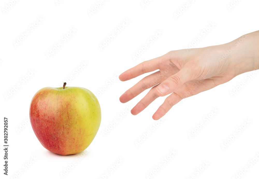 Woman's hand reaches for an red green apple on a white background Woman's hand reaches for an red green apple on a white background