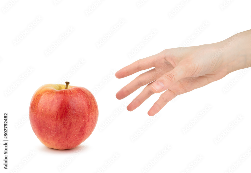Woman's hand reaches for an red apple on a white background Woman's hand reaches for an red apple on a white background