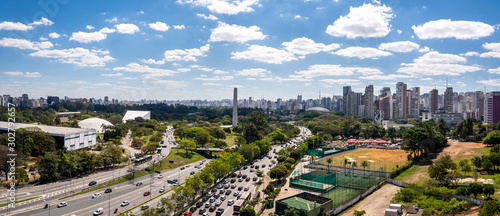 View of Ibirapuera Park, obelisk and building of the Sao Paulo city in sunny afternoon. Brazil.