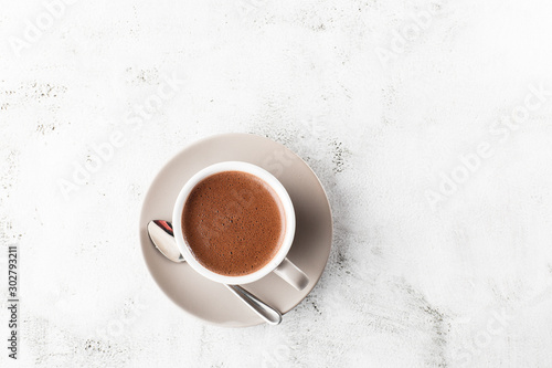 Cup of hot cocoa or hot chocolate or americano in white cup isolated on bright marble background. Horizontal photo. traditional drinks for winter time