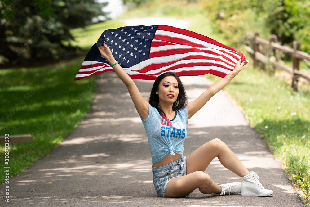 Beautiful asian girl posing with American Flag