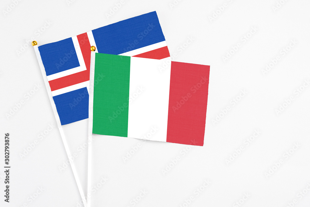 Italy and Iceland stick flags on white background. High quality fabric, miniature national flag. Peaceful global concept.White floor for copy space. Italy and Iceland stick flags on white background. High quality fabric, miniature national flag. Peaceful global concept.White floor for copy space.