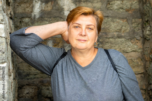 A thoughtful Mature plump woman walks the streets of the old city. Tallinn