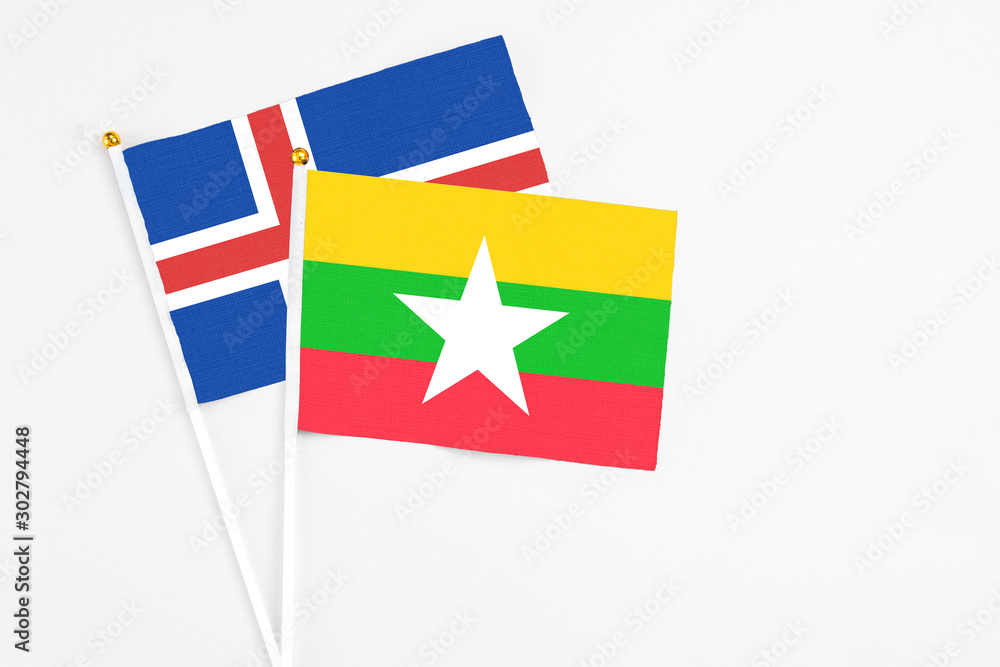 Myanmar and Iceland stick flags on white background. High quality fabric, miniature national flag. Peaceful global concept.White floor for copy space.