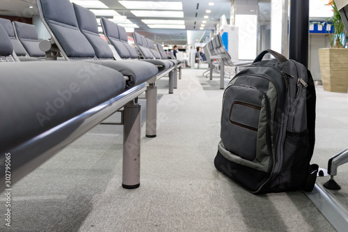 Unattended cabin backpack abandoned on the floor at the boarding waiting hall of an airport. © Ruben
