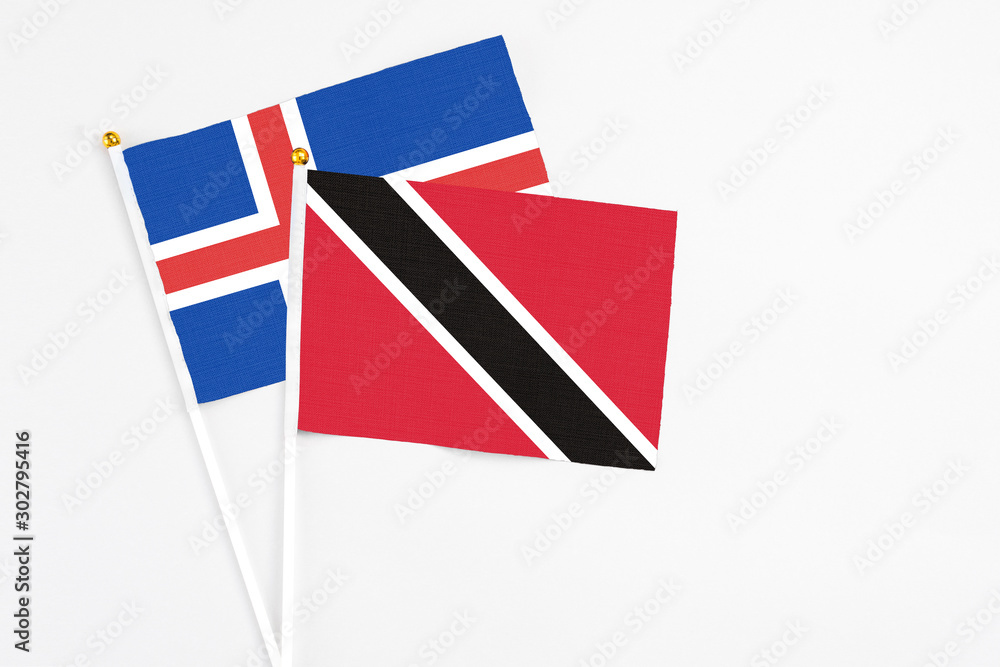 Trinidad And Tobago and Iceland stick flags on white background. High quality fabric, miniature national flag. Peaceful global concept.White floor for copy space. Trinidad And Tobago and Iceland stick flags on white background. High quality fabric, miniature national flag. Peaceful global concept.White floor for copy space.