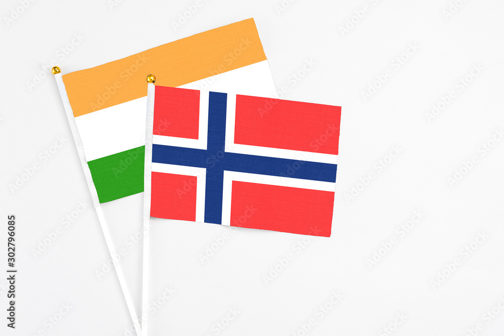 Bouvet Islands and India stick flags on white background. High quality fabric, miniature national flag. Peaceful global concept.White floor for copy space.