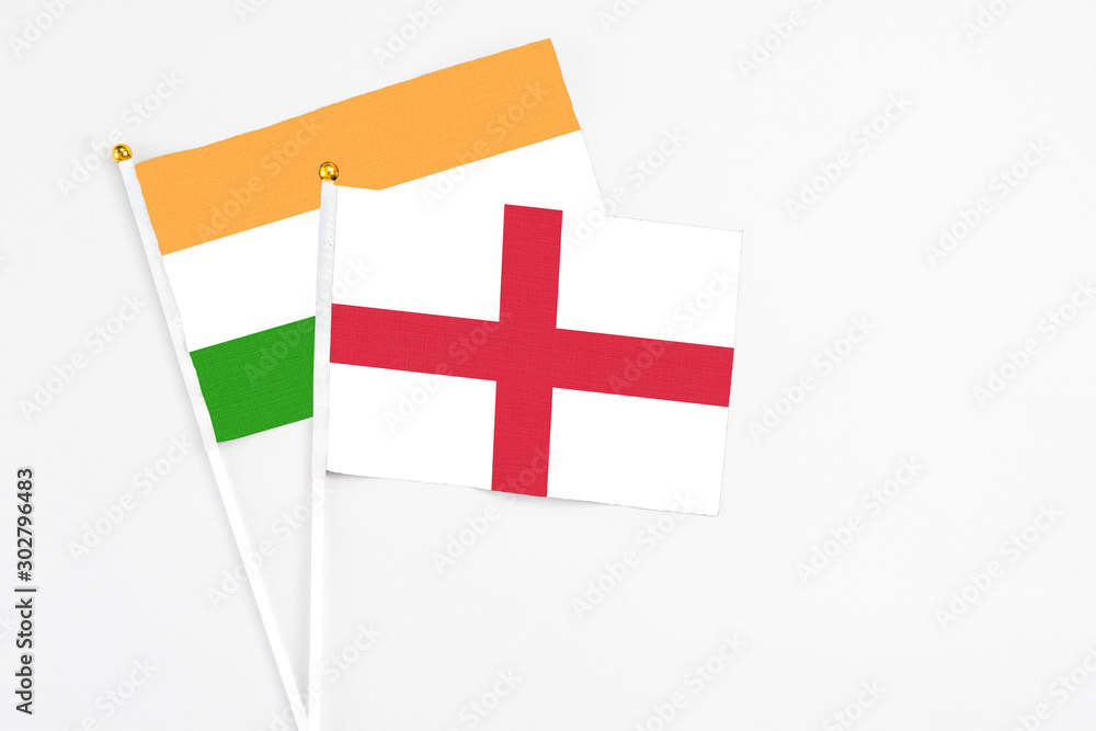 England and India stick flags on white background. High quality fabric, miniature national flag. Peaceful global concept.White floor for copy space.