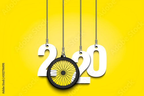 2020 New Year and bicycle wheel hanging on strings