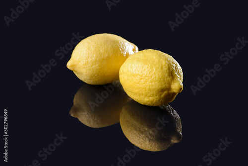 Lemons on black mirrored background
