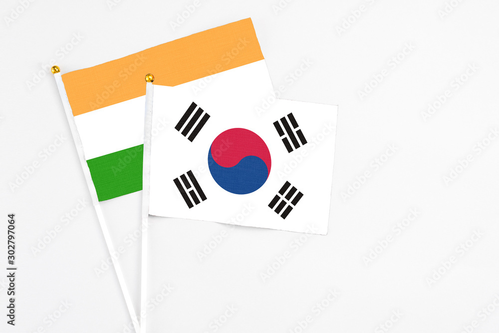 South Korea and India stick flags on white background. High quality fabric, miniature national flag. Peaceful global concept.White floor for copy space.
