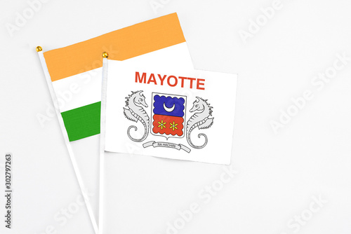 Mayotte and India stick flags on white background. High quality fabric, miniature national flag. Peaceful global concept.White floor for copy space.