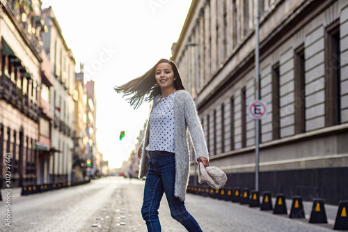  young woman walks on an empty street 