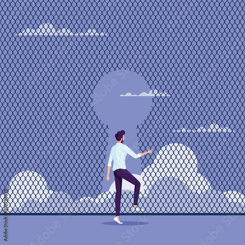 Breaking through to freedom Concept-Businessman escaping through the fence