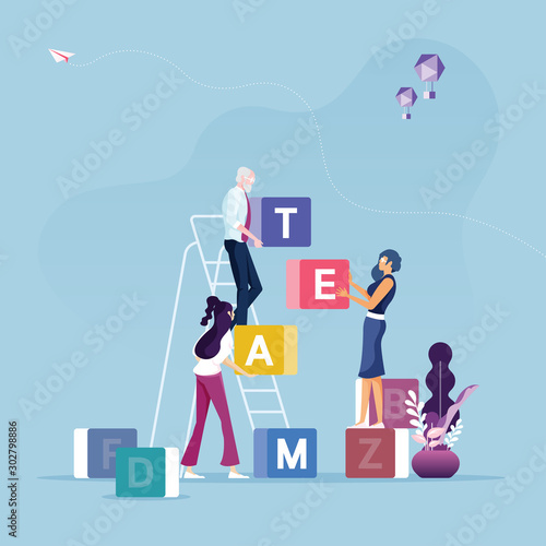 Group of business people carrying cubic box with word TEAM-Concept of teamwork