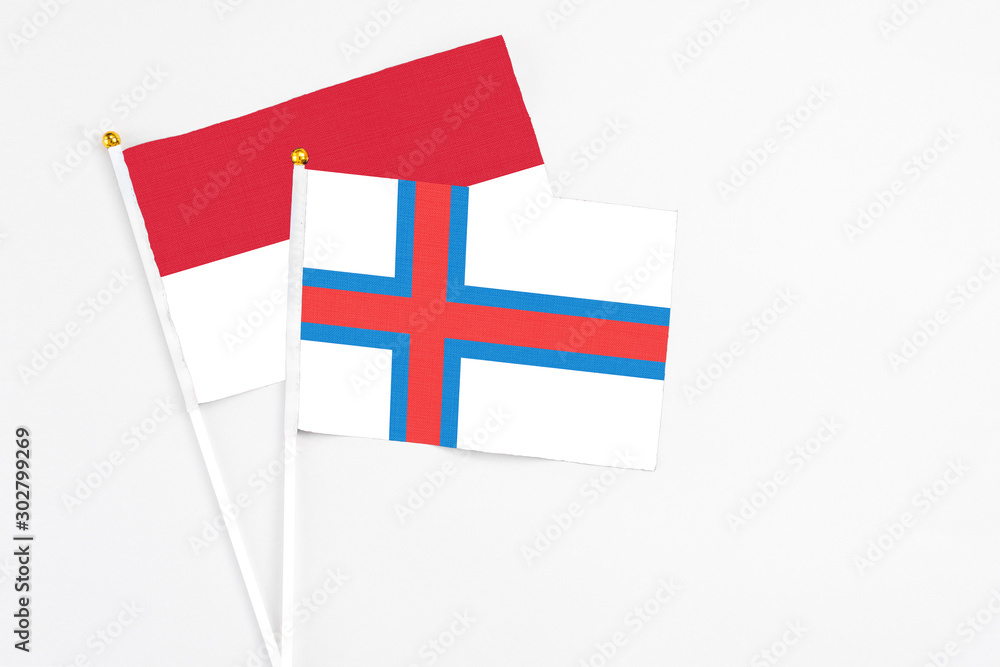 Faroe Islands and Indonesia stick flags on white background. High quality fabric, miniature national flag. Peaceful global concept.White floor for copy space.