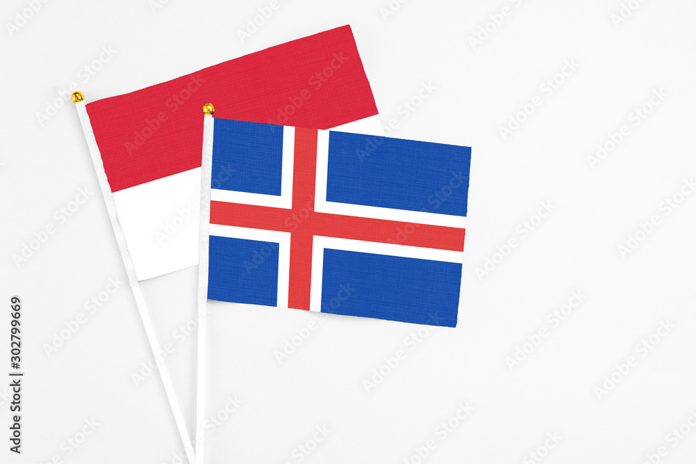 Iceland and Indonesia stick flags on white background. High quality fabric, miniature national flag. Peaceful global concept.White floor for copy space.