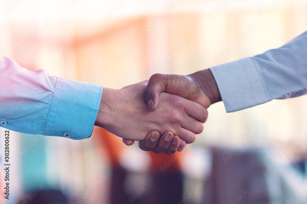 Handshake between african and a caucasian man. Handshake between african and a caucasian man.