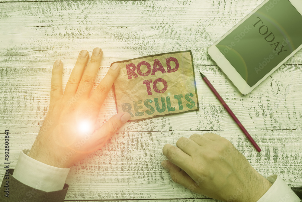 Obraz premium Text sign showing Road To Results. Business photo text Business direction Path Result Achievements Goals Progress Hand hold note paper near writing equipment and modern smartphone device