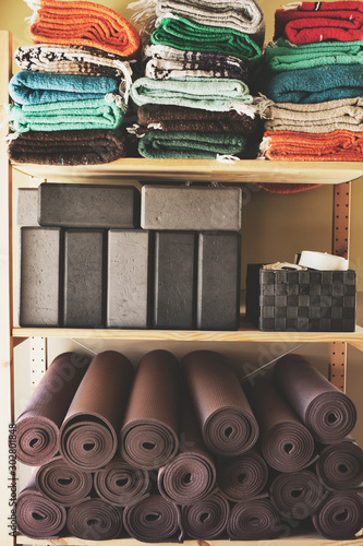 фотографія Yoga studio blocks, mats, blankets and other props.
