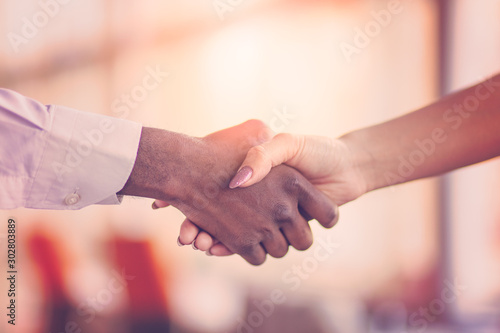 Handshake between african and a caucasian man.