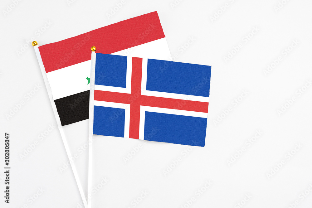Iceland and Iraq stick flags on white background. High quality fabric, miniature national flag. Peaceful global concept.White floor for copy space.
