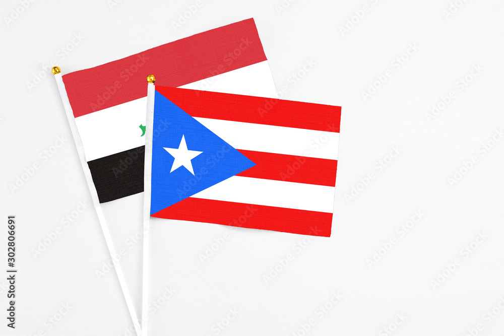 Puerto Rico and Iraq stick flags on white background. High quality fabric, miniature national flag. Peaceful global concept.White floor for copy space. Puerto Rico and Iraq stick flags on white background. High quality fabric, miniature national flag. Peaceful global concept.White floor for copy space.