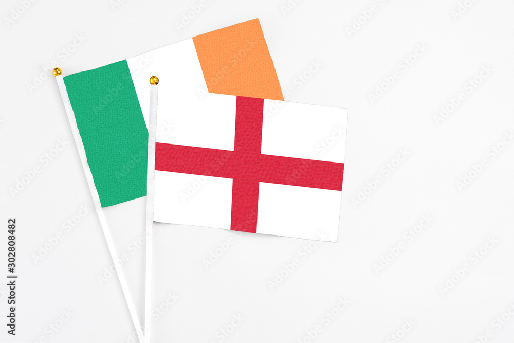England and Ireland stick flags on white background. High quality fabric, miniature national flag. Peaceful global concept.White floor for copy space