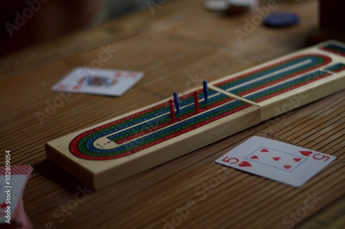 cribbage board with playing cards photo