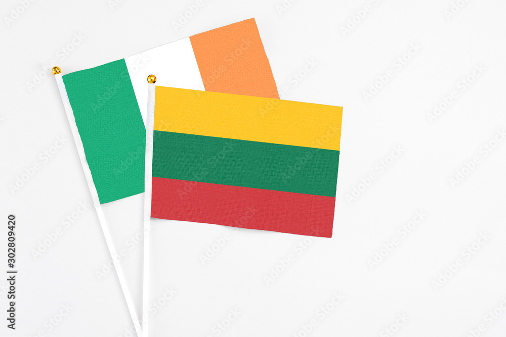 Lithuania and Ireland stick flags on white background. High quality fabric, miniature national flag. Peaceful global concept.White floor for copy space Lithuania and Ireland stick flags on white background. High quality fabric, miniature national flag. Peaceful global concept.White floor for copy space