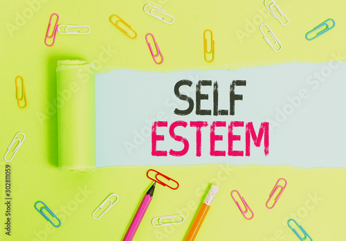 Word writing text Self Esteem. Business photo showcasing a feeling of having respect for yourself and your abilities Stationary and torn cardboard placed above a plain pastel table backdrop photo