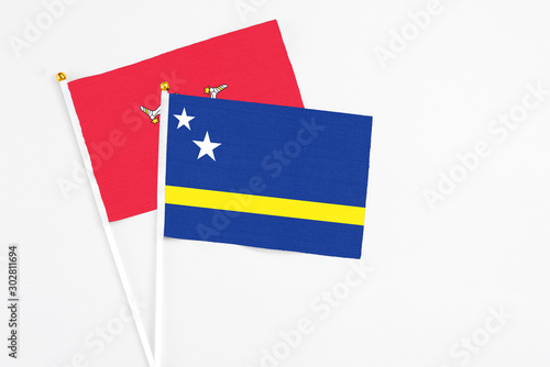 Free Download Curacao and Isle Of Man stick flags on white background. High quality fabric, miniature national flag. Peaceful global concept.White floor for copy space. - GFXLoad