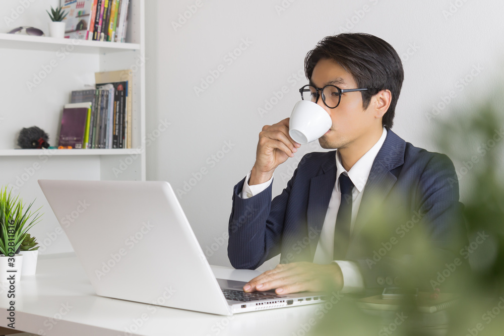 Asian Businessman Wear Eyeglasses and Drink Coffee Asian Businessman Wear Eyeglasses and Drink Coffee