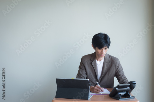 Aฺsian business man in room and action stance with copy space.