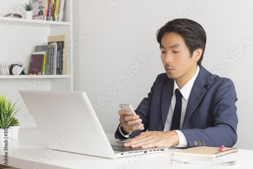 Asian Financial Advisor or Asian Consulting Businessman Sending Message or Chat