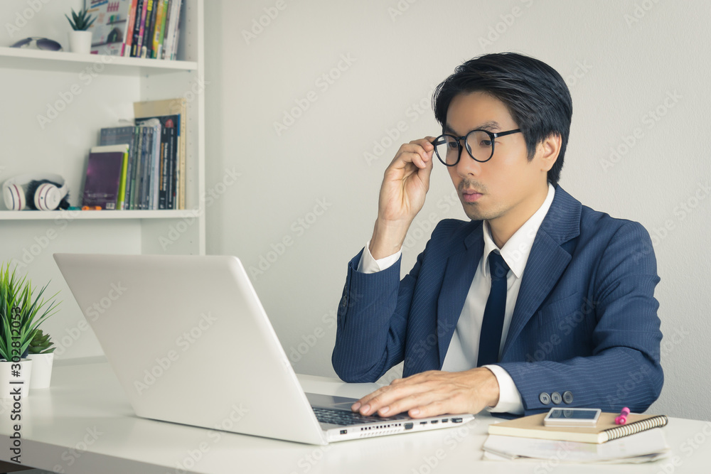 Asian Financial Advisor or Asian Consulting Businessman Consider Data in Vintage Tone Asian Financial Advisor or Asian Consulting Businessman Consider Data in Vintage Tone