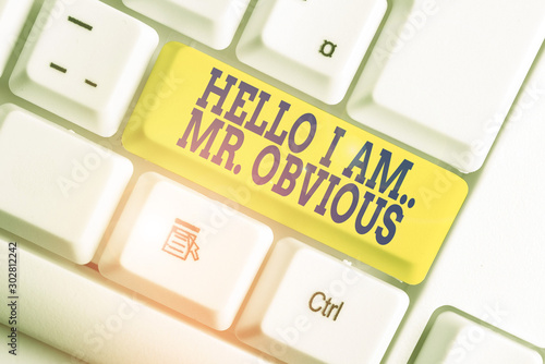 Text sign showing Hello I Am Mrobvious. Business photo text introducing yourself as pouplar or famous demonstrating White pc keyboard with empty note paper above white background key copy space photo