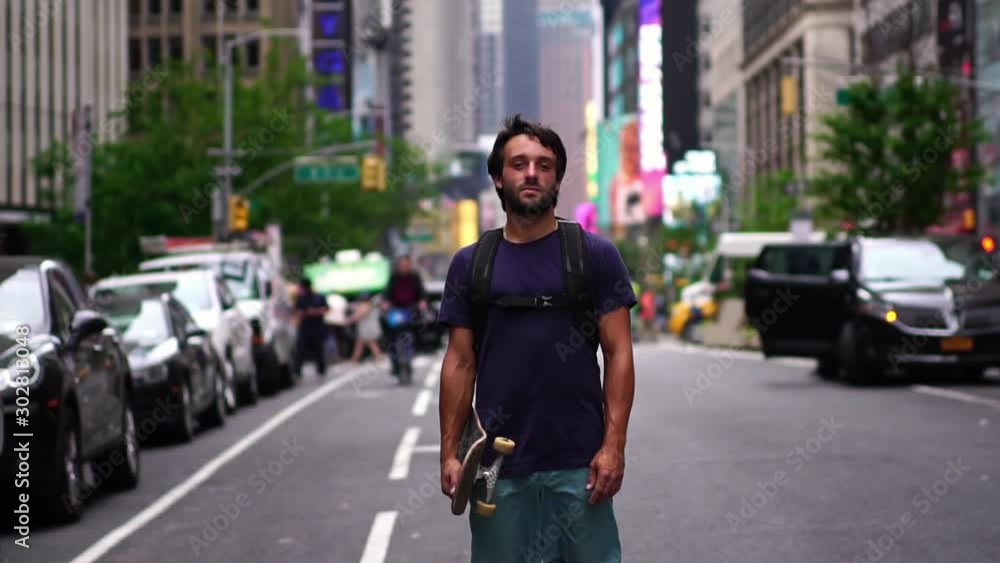 Portrait of confident millennial new yorker. Skateboarder guy holding skateboard. Concept of urban healthy active lifestyle, adventure, american youth, hipster in NYC. Portrait of confident millennial new yorker. Skateboarder guy holding skateboard. Concept of urban healthy active lifestyle, adventure, american youth, hipster in NYC.