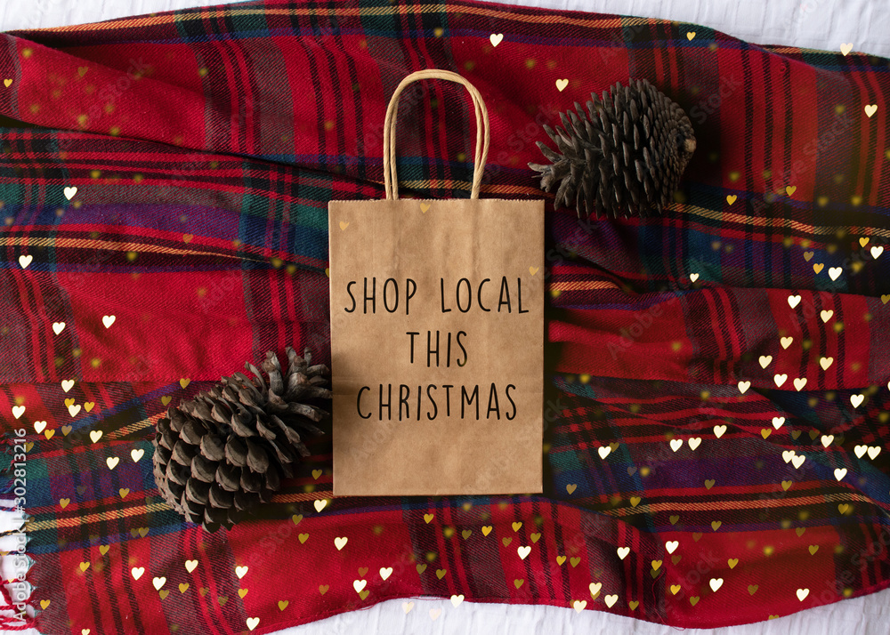 Local This Christmas" text on a plain brown paper bag flat lay