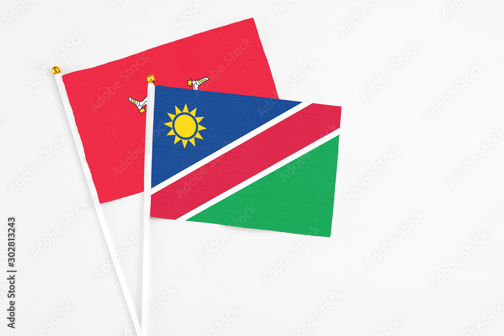 Namibia and Isle Of Man stick flags on white background. High quality fabric, miniature national flag. Peaceful global concept.White floor for copy space. Namibia and Isle Of Man stick flags on white background. High quality fabric, miniature national flag. Peaceful global concept.White floor for copy space.