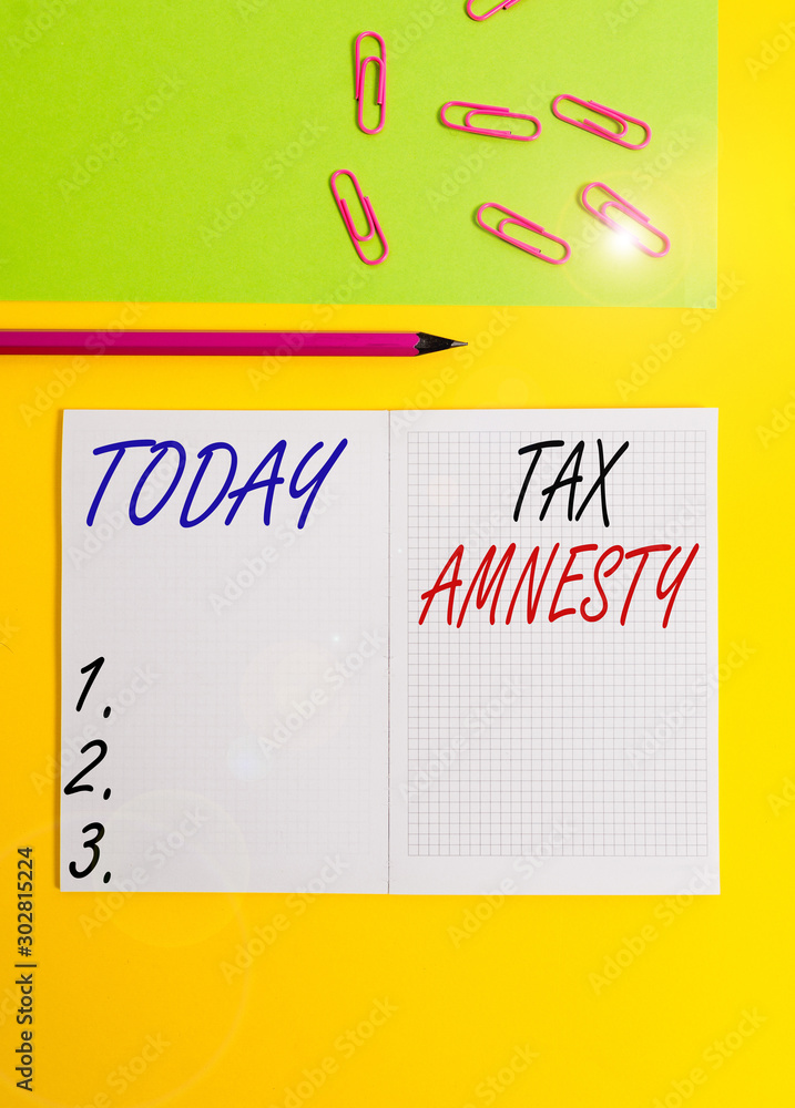 Handwriting text writing Tax Amnesty. Conceptual photo limitedtime opportunity for specified group of taxpayers to pay Blank squared notebook pencil marker paper sheet plain colored background