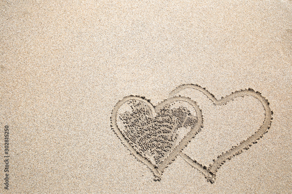Nature design heart to love of crab rolls ball from sand on the beach as background with copy space Nature design heart to love of crab rolls ball from sand on the beach as background with copy space